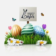 Easter greeting card with colorful eggs and flowers in the grass