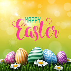 Colorful Easter eggs with daisies flowers on the grass