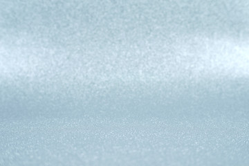 Shiny silver defocused glitter background with copy space.