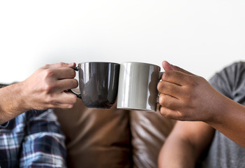 Men toasting coffee cup together