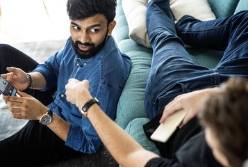 Diverse friends talking together at home