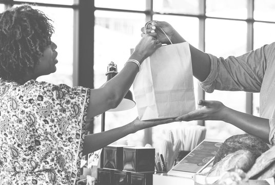 Black customer buying bakery products