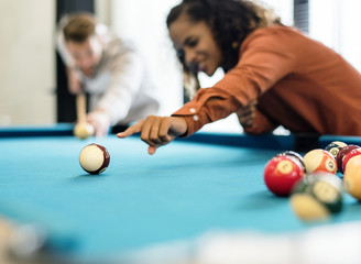 Happy friends playig pool together