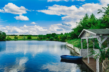 Obraz premium The jetty and Old lonely wooden boat floating on the water.