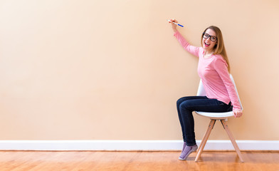 Young woman drawing something on a big open wall