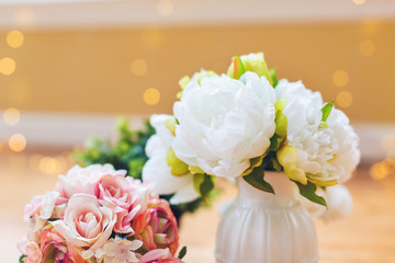 A group of flowers in a bright interior room
