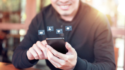 Happy man hands using mobile smartphone with icon social media and social network.