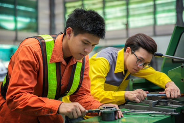 Asian engineer and worker setting machine for process metal job, this immage can use for job,...