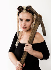 Beautiful sexy worker with a pickaxe. Seductive and beautiful woman miner on a light background