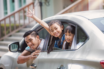 Father and daughter on car and smile from car windows before start family travel trip in holiday, this immage can use for family , travel, car, weekend, and summer concept