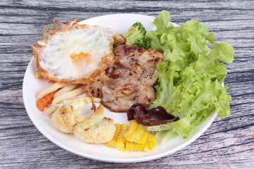 Chicken steak and grilled mixed vegetables .
