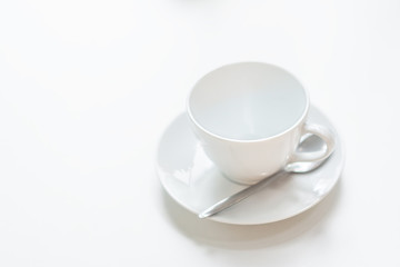 Ceramic coffee cup on the white table
