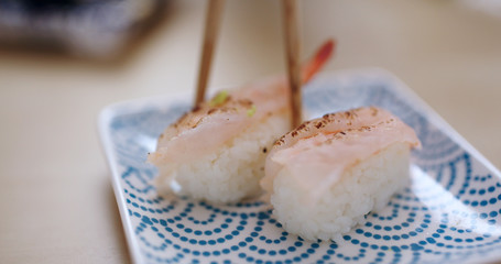 Having grilled shrimp sushi