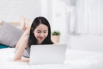 Obraz na płótnie Canvas Cute Asian woman using laptop at home,