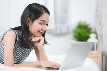 Asian woman using laptop at home,