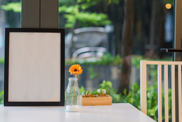 Beautiful gerbera flower in bottle glass with phhoto frame interior decoration