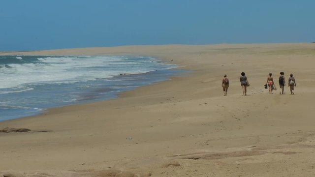 Tourists walk on a beach in the Cabo Polonio national park in Uruguay.