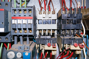 A group of electrical relays with connected wires.