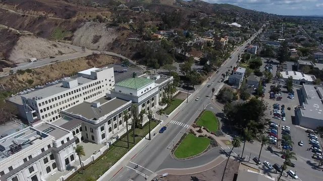 Aerial Flyover - Downtown Ventura - hillside view of city hall and apartments - flying backward