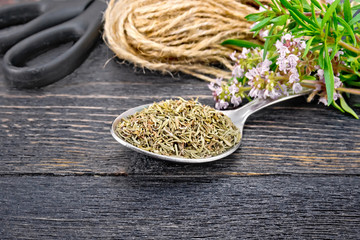 Thyme dry in spoon with scissors on board