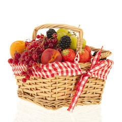 Wicker basket with mixed summer fruit