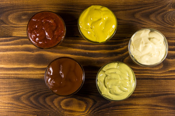 Set of sauces on wooden table