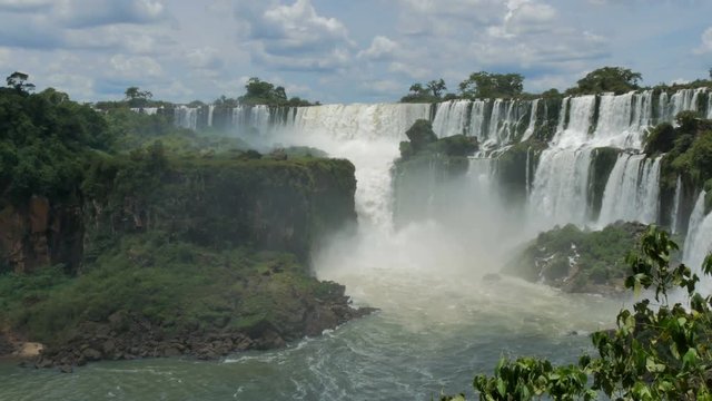Waterfalls pouring water into the river in the Iguazu National Park in Argentina.