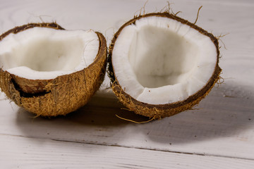 Fresh ripe coconut on white wooden table