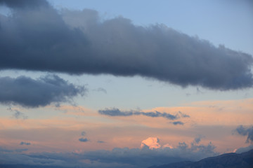 Fototapeta premium clouds over high altitude mountains during sunrise