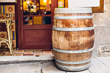 An old wooden barrel at the entrance to the cafe. Barcelona, Catalonia, Spain.