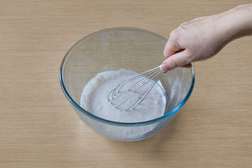 Cooking and mixing in a bowl to prepare a cream