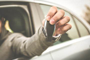 Close up of human hand holding car key.