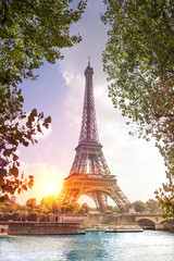 Fototapeta na wymiar Romantic sunset background. Eiffel Tower with boats on Seine river in Paris, France.
