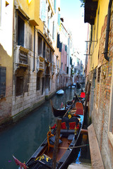 Fototapeta na wymiar Venetian Gondolas in a side canal just off The Grand Canal, Venice