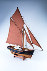 Miniature of a sloop ship brown and black isolated in gray background