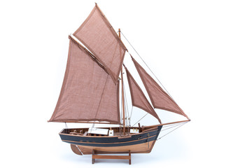 Miniature of a vintage pirate sloop ship brown and black with anchor isolated in white background...