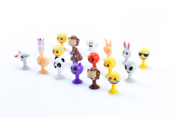 Funny smiley face icons or yellow emoticons in lines with emotional funny faces in plastic toy realistic isolated in white background