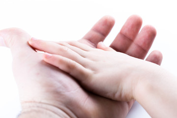 Child hand on a man hand isolated in white background