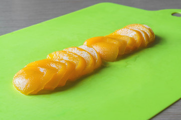 Slices and halfs of peach