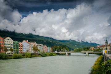 Fototapeta na wymiar Multi-colored houses by the river bank. Innsbruck, Austria 