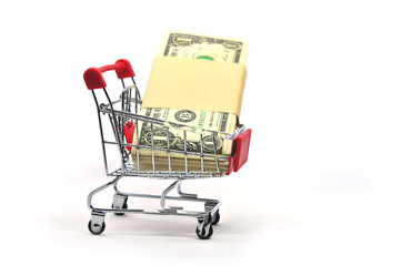 Stack of money in a shopping cart isolated on white background