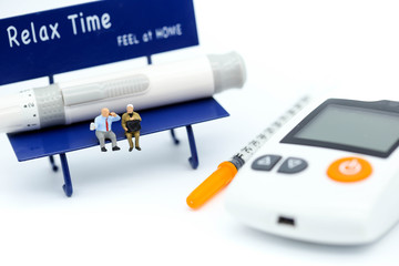 Miniature people : people sitting on chair with Diabetes blood glucose test with Syringe,Healthcare concept.
