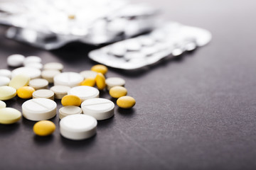 Tablets and capsules are scattered on the table