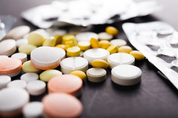 Tablets and capsules are scattered on the table
