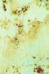 Background of rusty metal painted in green paint.