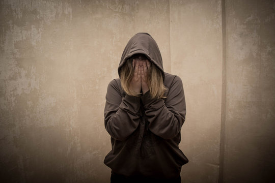 Hopeless drug addict holding his head. portrait of young person with substance dependence