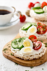 Open sandwiches of rice cakes with cream cheese , vegetables and quail egg