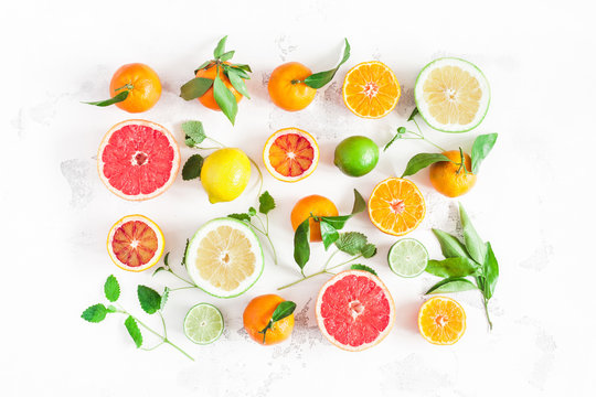 Fruit background. Colorful fresh fruits on white table. Orange, tangerine, lime, lemon, grapefruit. Flat lay, top view