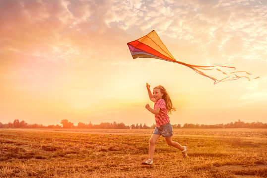 child running flying kite