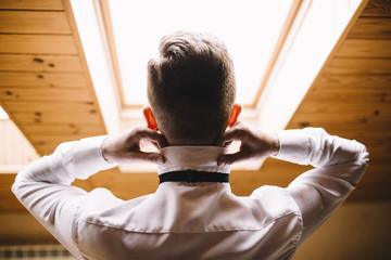 the groom adjusts his jacket, groom in a jacket, The morning of